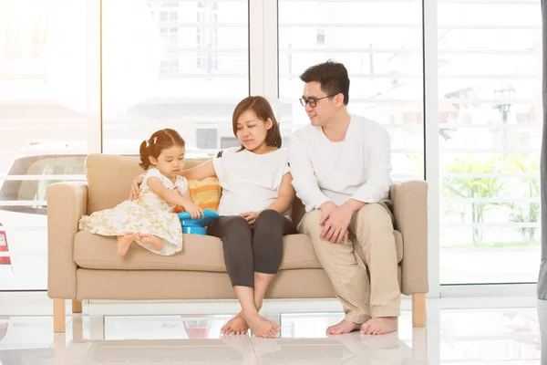 Family relaxing on sofa — Stock Photo, Image