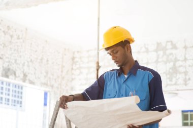construction worker looking at plans clipart