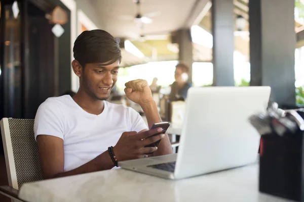 Mann benutzt Smartphone und Laptop — Stockfoto