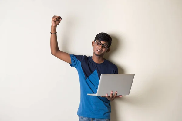 Indian young man with laptop — Stock Photo, Image