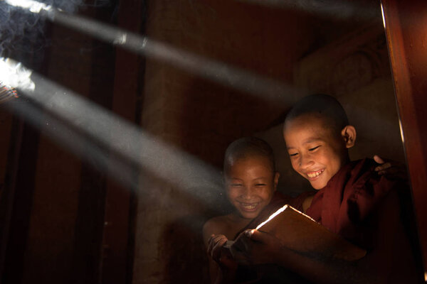 monks reading in monastry in sunlight rays