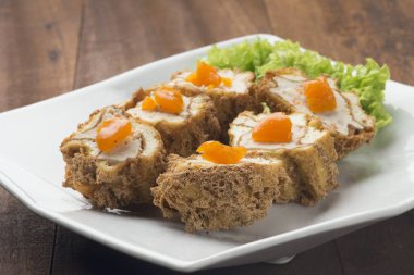 ahşap masa üzerinde beyaz plaka üzerinde kızarmış dim sum 