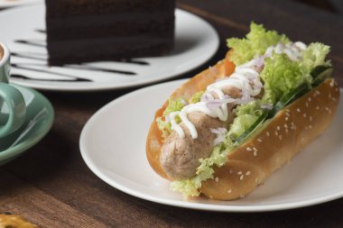 Sosisli sandviç kahvaltı beyaz plaka üzerinde 