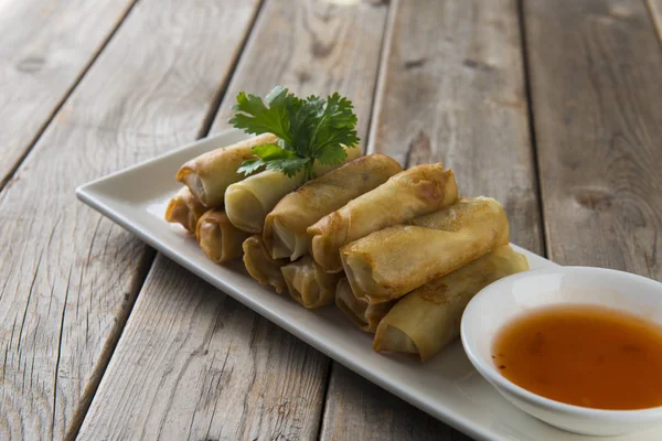 Lumpia Spring Rolls on Wooden Table in Restaurant