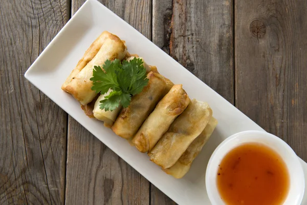 Lumpia Spring Rolls on Wooden Table in Restaurant