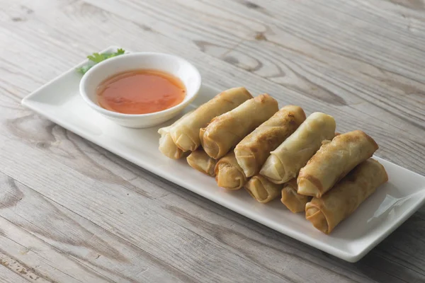 Lumpia Spring Rolls on Wooden Table in Restaurant