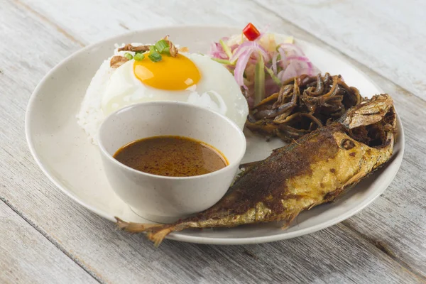 fried fish with rice with spices and curry