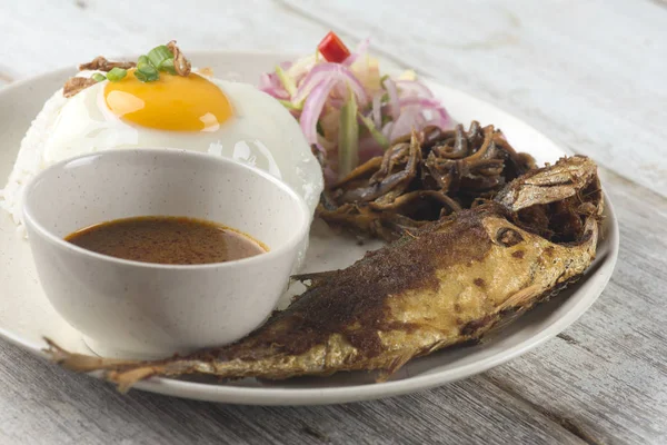 fried fish with rice with spices and curry