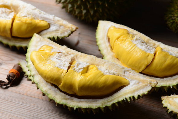 Durian riped and fresh, durian peel with yellow colour on wooden table
