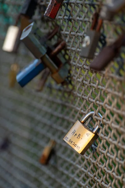 Picture taken on a morning walk during sunrise, in wierklaniec. It presents a closed padlock suspended by a young couple, which symbolizes the sealing of the marriage and relationship of two people.