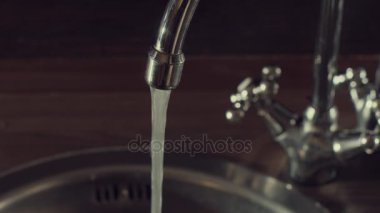 Bir su musluktan akan suyun