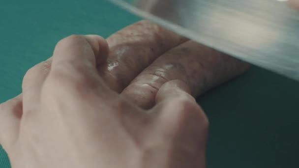 Man cuts some sausages on the plastick board — Stock Video