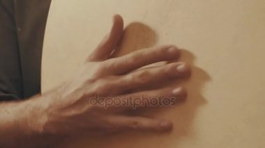 El bir çerçeve davul çalmaya müzisyen
