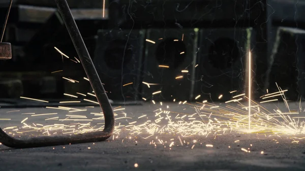 Close up sparks of welding falling on the floor