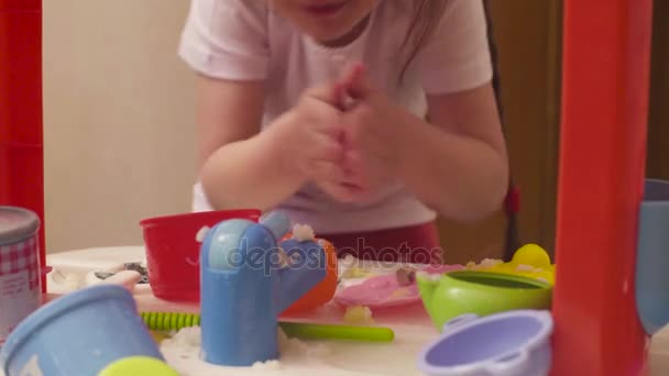 Hands of little girl playing with dishes and food — Stock Video