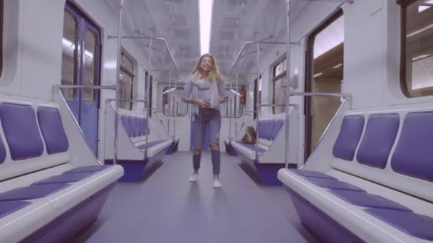 Young woman dancing in subway train — Stock Video