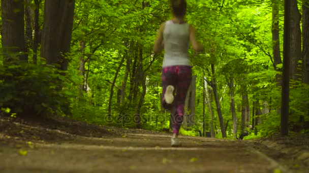 Young woman running in the park — Stock Video