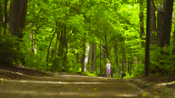 Young woman running in the park — Stock Video