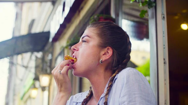 stock image Portrait of young woman eating cookie