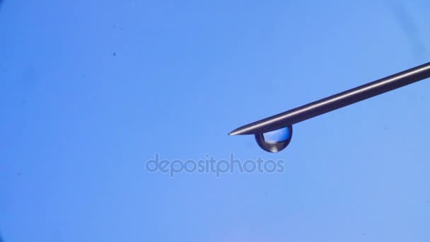 Water drop falling from the syringe needle — Stock Video