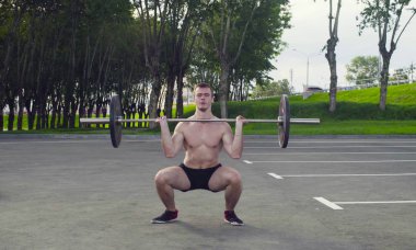 Genç bir adam halter kaldırma