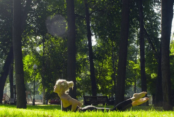 Jeune femme faisant des exercices de yoga dans le parc — Photo