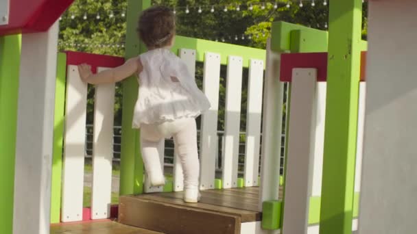 Baby girl walking on the playground — Stock Video