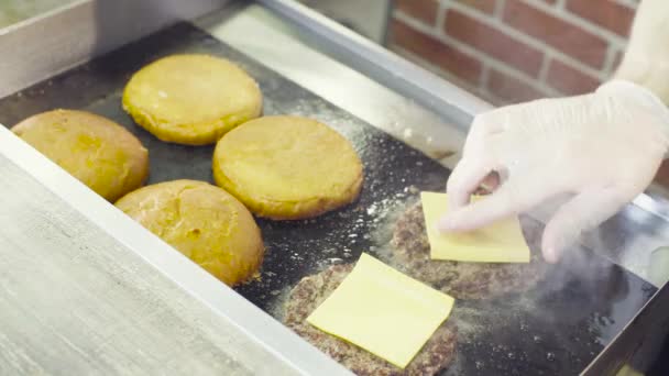 Mãos de chef queimando um hambúrguer com uma chama aberta — Vídeo de Stock