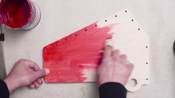 Ман вручную раскрашивает мебельную деталь с помощью пластика — стоковое видео
