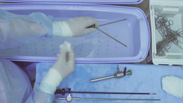 Hands of the nurse washing medical instrument — Stock Video