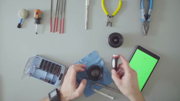 Green screen. Hands with screwdriver repair lens — Stock Video