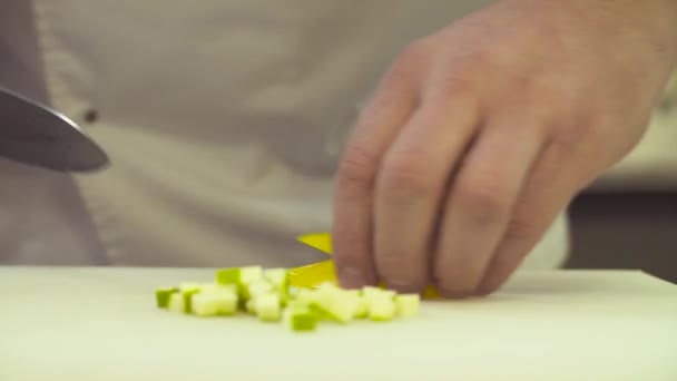 Mãos de chef cortando uma páprica com uma faca — Vídeo de Stock