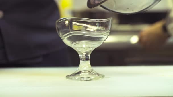 Руки шеф-повара кладут грибы в стеклянную миску — стоковое видео