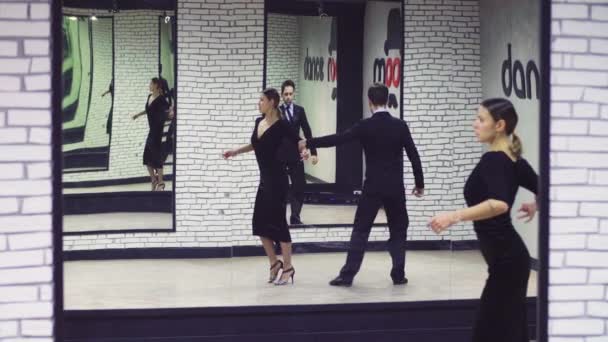 Professional dancers dancing tango in ballroom. — Stock Video