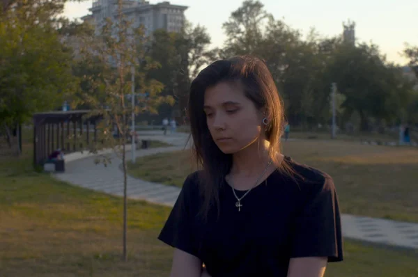 Portrait of young pensive woman in the park — ストック写真