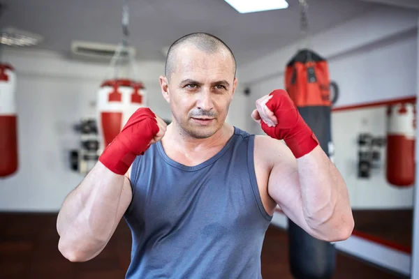 Boxer working on punchbags — Stock Photo, Image