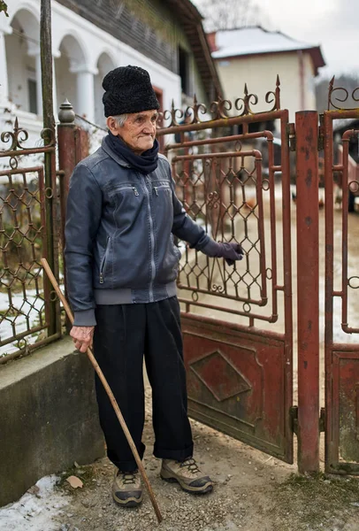 Old farmer  opening the door — Stock Photo, Image