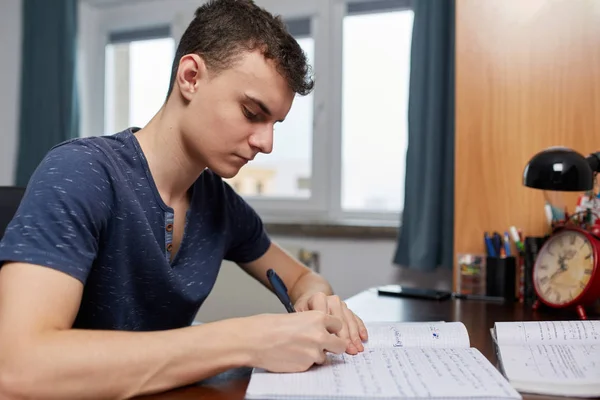 Teenager doing homework with computer — Stock Photo, Image