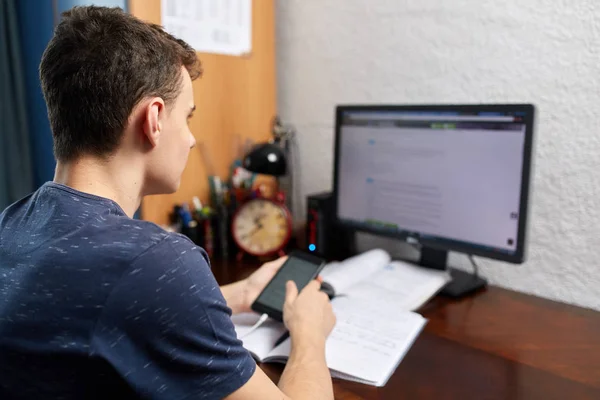 Teenager doing homework with computer — Stock Photo, Image