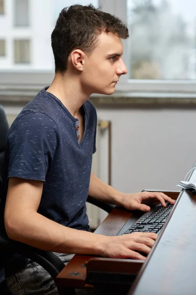 Teenager doing homework with computer — Stock Photo, Image