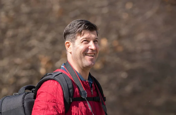 Happy mature man with backpack — Stock Photo, Image