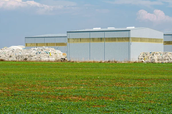 Industrial warehouses and piles of garbage — Stock Photo, Image