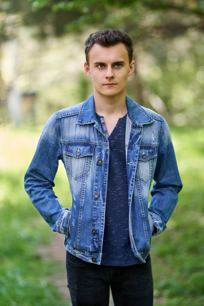 Teenage boy standing in forest — Stock Photo, Image