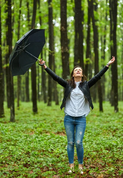 Woman with umbrella in park — Stock Photo, Image