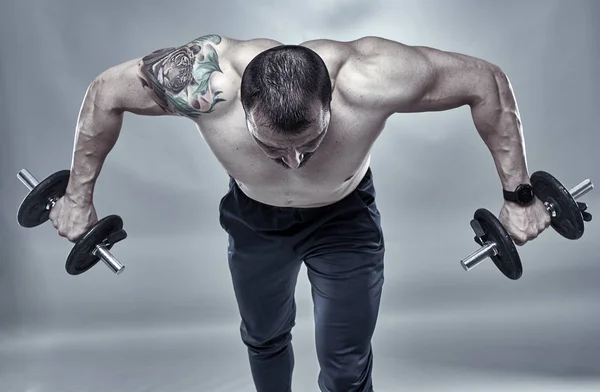 Fitness trainer doing shoulder workout — Stock Photo, Image