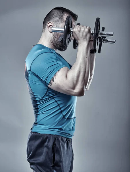 Fitness trainer doing shoulder workout — Stock Photo, Image