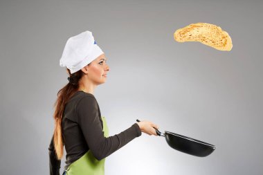 Woman cook flipping pancake clipart