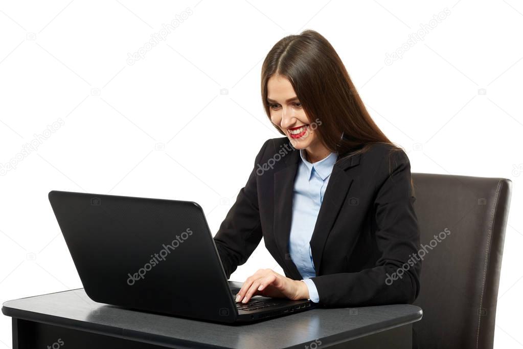 Businesswoman using laptop at her desk