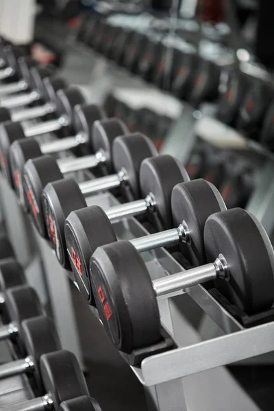 Dumbbells on rack in gym — Stock Photo, Image