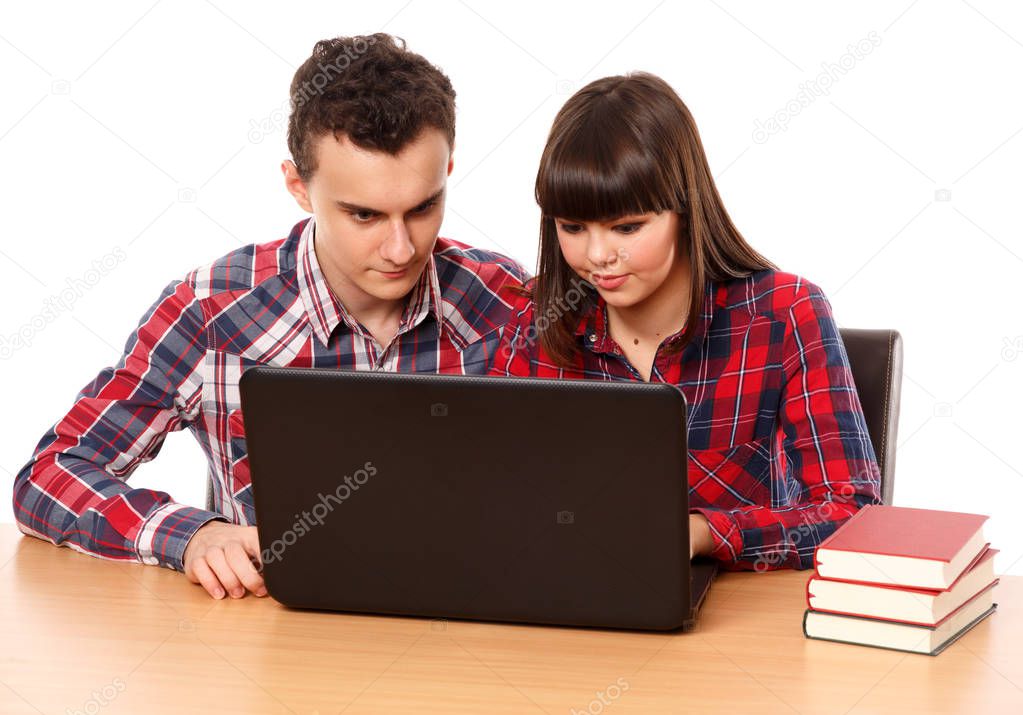 Two teenagers studying together with laptop